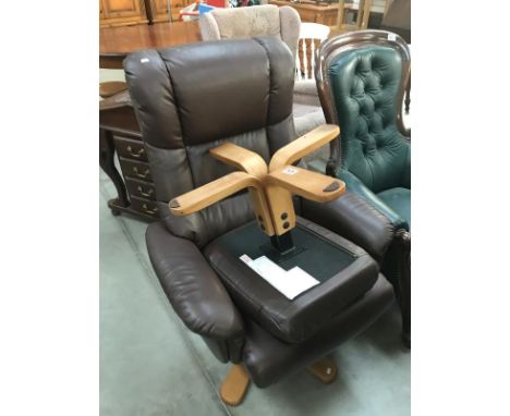 A brown leather recliner swivel chair &amp; stool