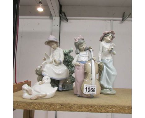 4 NAO figurines being lady sitting with doves, lady with dove, girl with cello and geese.