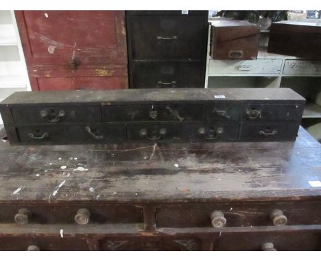 A vintage storage unit/ drawers containing engineers tools