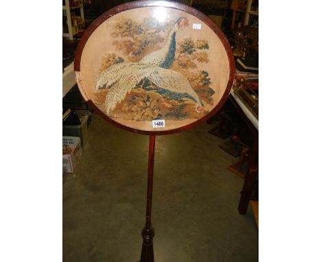A Victorian mahogany pole screen with tapestry panel.