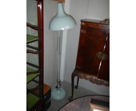 An angle poise floor lamp.