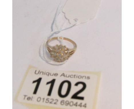 A half carat yellow gold floral diamond ring, size K.