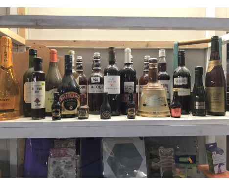 A shelf of alcohol, including wine etc.