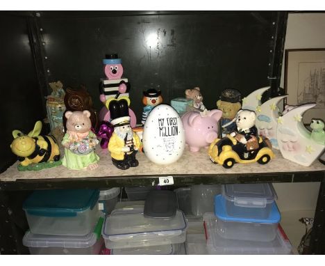 A shelf of assorted money boxes