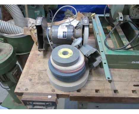 A bench grinder and wheels with maxi clamp