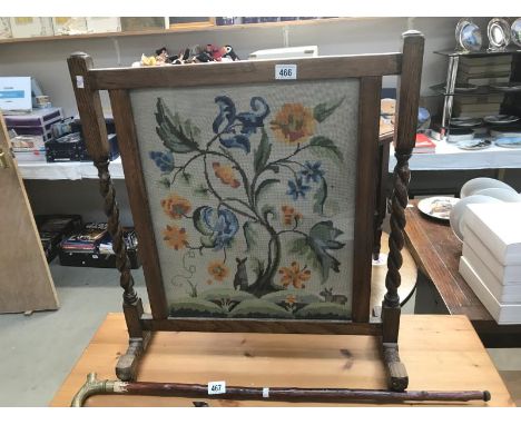An embroidered fire screen