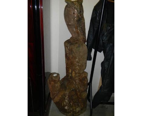 A carved tree trunk being owls perching.