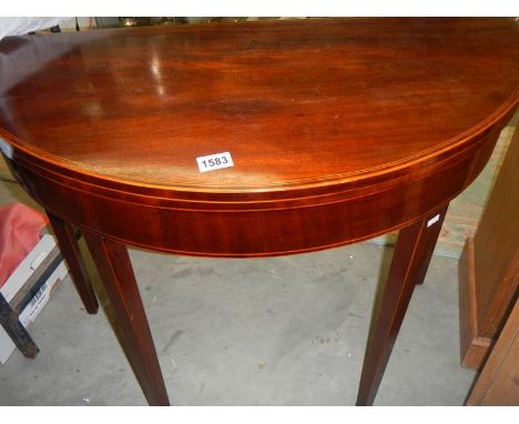 A D shaped fold over card table with string inlay.