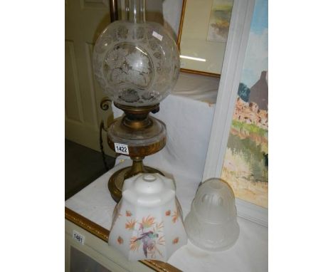 An oil lamp with glass font and original acid etched shade together with 2 1930's glass lamp shades.