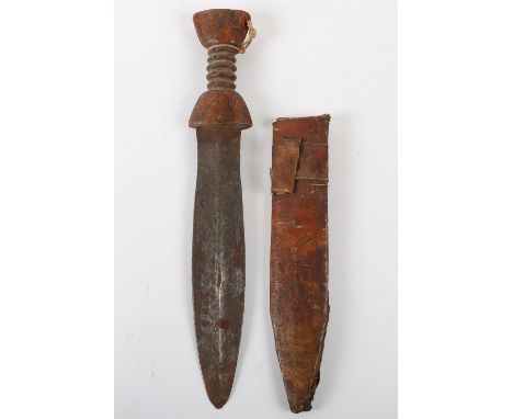 African Tribal Knife, with carved wooden handle having central groves. Slightly swollen blade with some surface rusting. Hous