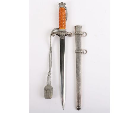 WW2 German Army Officers Dagger, having orange grip with the pommel having oakleaves relief. Cross guard in the form of a Ger