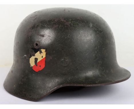 WW2 German Army M-35 Steel Combat Helmet, example with a darker green overpaint finish to the exterior of the shell. Helmet h