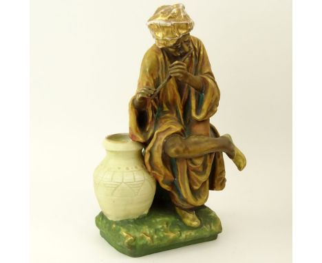 Early 20th Century Austrian Amphora Porcelain Figure, Arab Man Playing Flute. Impressed marks to base. Rubbing to Gilt Decora