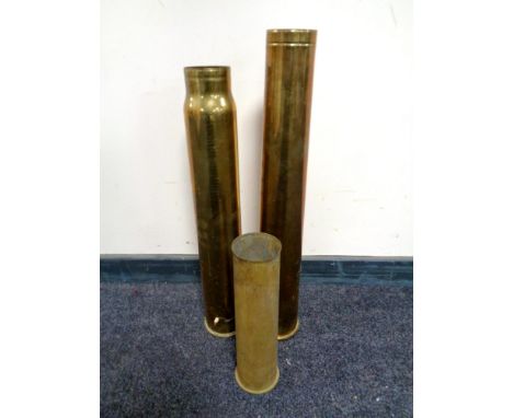 Three brass ammunition shell casings  