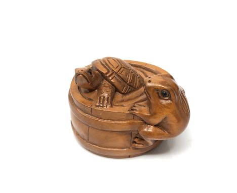 A carved Chinese hardwood netsuke - Frog and turtle in barrel