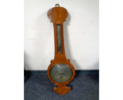 An antique banjo barometer by T Littlewood with silvered dial  