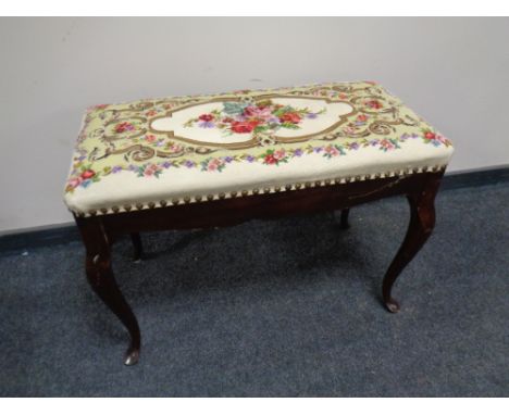 A stained beech wood dressing table stool with a floral tapestry seat  