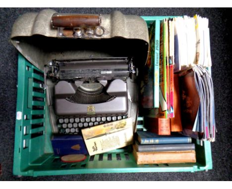 A crate containing a vintage metal cased typewriter, assorted books, Viz comics, Newcastle United Football programmes 