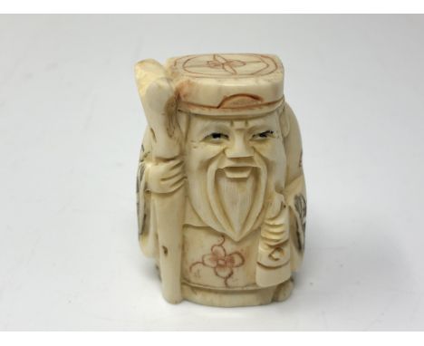A carved Chinese bone netsuke  - Gentleman holding a staff