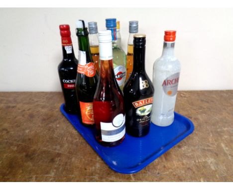 A tray containing nine bottles of alcohol to include Cockburn's Port (75cl), two bottles of Taboo Infused Vodka (70cl), Angel