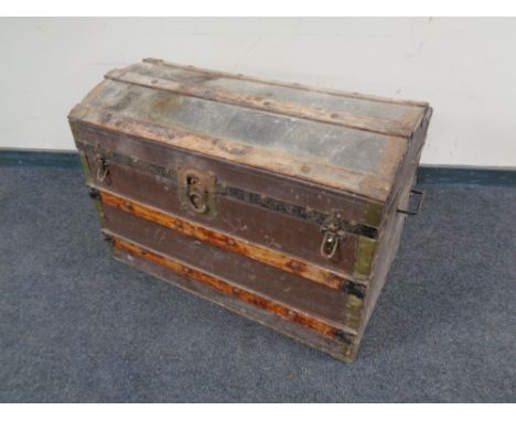 An early 20th century wooden bound dome topped shipping trunk  