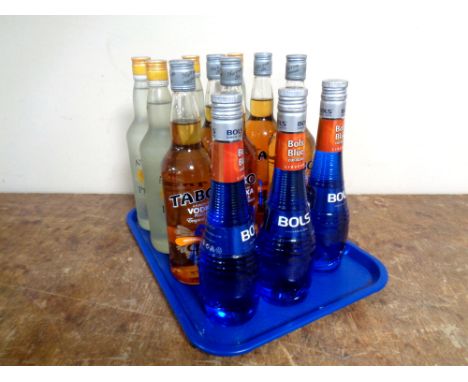 A tray containing twelve bottles of alcohol to include three bottles of Bol's Liqueur (500ml), five bottles of Taboo Infused 