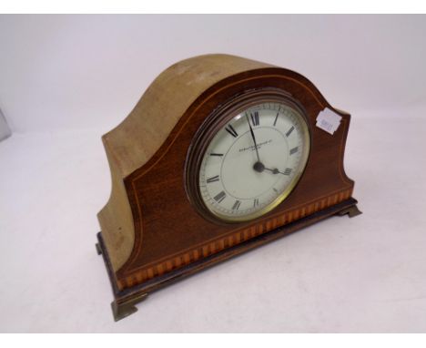 An Edwardian inlaid mahogany mantel clock retailed by Evelyn Bishop Limited of Leeds, on raised brass feet 