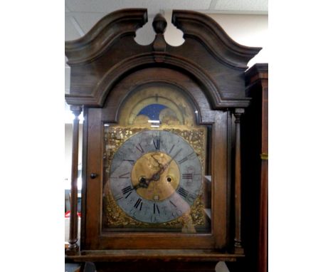 A 20th century oak cased longcase clock with brass moon phase dial, pendulum and weights  
