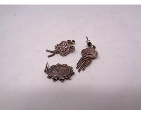 A vintage silver pendant and earrings