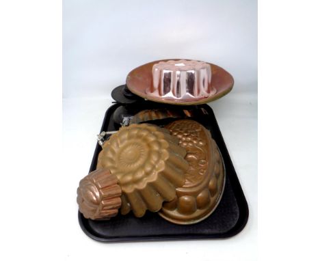 A tray containing a set of vintage metal scales, five antique and later copper jelly moulds   