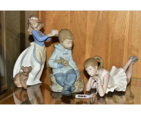 THREE NAO FIGURES, comprising Ballerina, pensive, length 22.5cm, a boy sitting with rabbit and satchel, height 16cm, and 'Pup