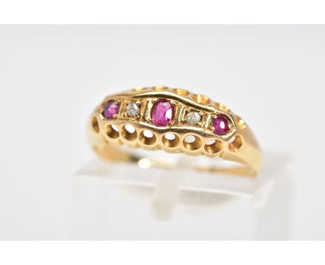 AN EARLY 20TH CENTURY 18CT GOLD RUBY AND DIAMOND RING, the boat shaped top panel set with a line of three graduated rubies in