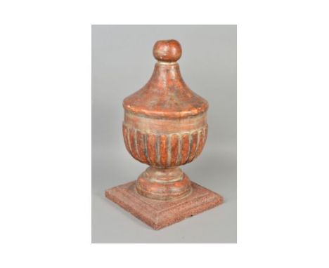 A 19TH CENTURY PAINTED GESSO FINIAL, the carved wooden urn shaped finial on a circular foot painted a brown/orange and silver