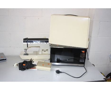 A MORRISONS MICROWAVE (PAT pass and working) and a Singer Touch-Tronic 2000 sewing machine with case and manual (PAT fail due