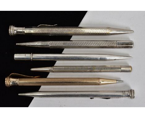 A SELECTION OF SIX RETRACTABLE PENCILS, four designed with engine turned patterns, together with two plain polished pencils, 