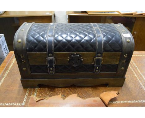 A faux leather dome top trunk