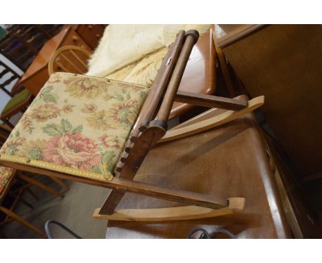 A tapestry covered rocking foot stool