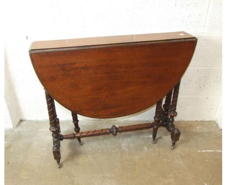 A late Victorian oval mahogany Sutherland table on turned end-supports and stretchers, 103 x 91cm open, and a Victorian carve