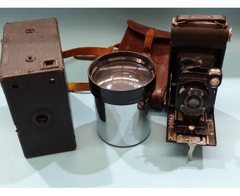 A Taylor-Hobson chrome 5-inch f/1.5 projection lens no.284763, an Eastman Kodak A120 folding camera and a Houghton Butcher "E