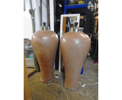 A pair of very large lamp bases 43" tall in a brown/ light terracotta colour with glazed effect, with metal trim around botto