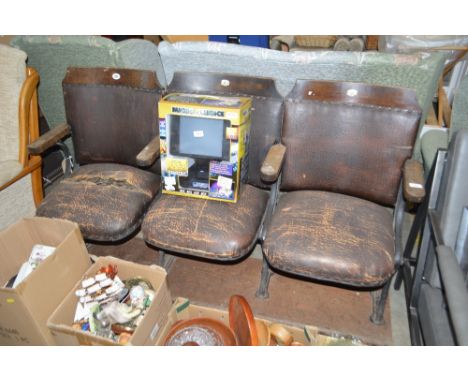 A set of three vintage cinema seats