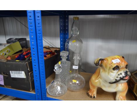 Three decanters and stoppers and a Bell's scotch whisky bottle