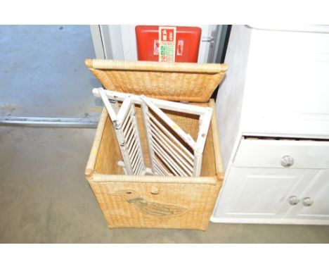 A wicker linen basket; and a vintage plate rack