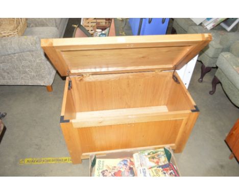 A light oak blanket box