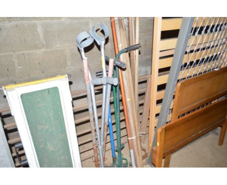 A quantity of long handled tools and a pair of crutches etc