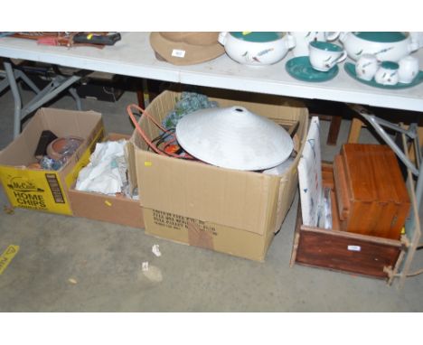 Four boxes containing various linen, mantel clock, enamelled light shade etc.