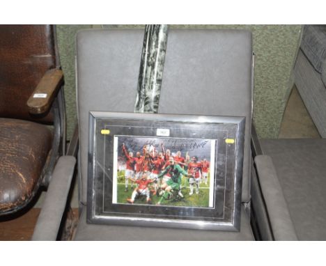 A framed and glazed Manchester United print and a poster of Ed Sheeran 