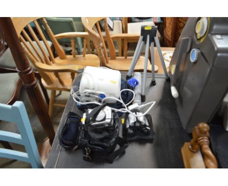 An Olympus camera; a pair of binoculars; tripod etc.