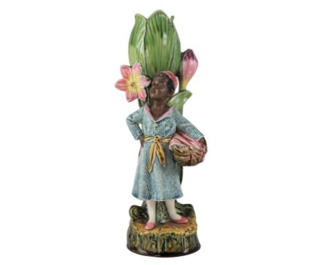 Ceramic vase modeled with North African child holding a basket and standing before a floral motif. "As is" condition as crack