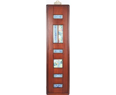 Chinese wooden frame has six openings with glazed ceramic images. Size: 49 1/2 x 12 1/2 in.